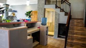 a kitchen with a stairs and a room with a refrigerator at Dana Homestay in Canggu