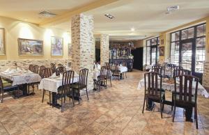 a restaurant with tables and chairs in a room at Hotel TERESITA in Kraków +16 photos