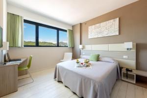 a hotel room with a bed and a desk at Hotel Cristina in Naples