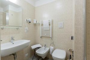 a bathroom with a sink and a toilet at Hotel Cristina in Naples