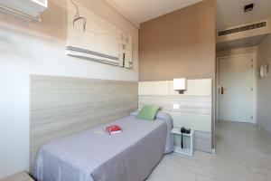 a bedroom with a bed with a book on it at Hotel Cristina in Naples