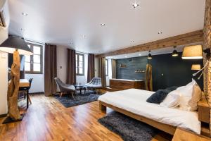 a bedroom with a bed and a desk in a room at Les suites sainte claire in Annecy