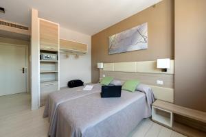 a bedroom with a large bed with green pillows at Hotel Cristina in Naples