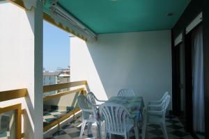 a patio with a table and chairs on a balcony at FLATS SOLARIUM in Bibione
