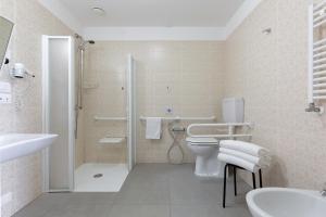 a bathroom with a shower and a toilet and a sink at Hotel Cristina in Naples