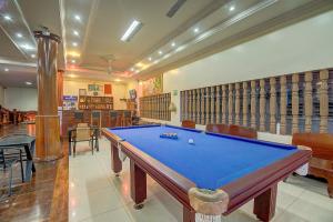a room with a pool table in a room with shelves at DV Angkor Villa in Siem Reap