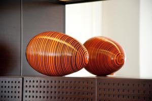 two orange plates sitting on top of a shelf at The Levante Parliament A Design Hotel in Vienna