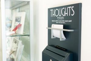 a sign on the wall of a store with a drawer at Hotel Cristina in Naples