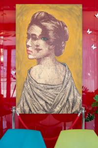 a painting of a woman on a wall at Hotel Cristina in Naples