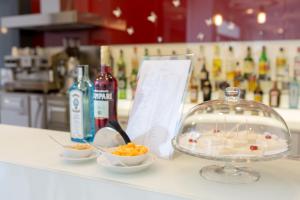 a counter with a bowl of food and a bowl of fruit at Hotel Cristina in Naples