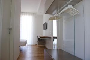 a kitchen with white walls and a table in a room at Chiaroscuro in Belforte del Chienti