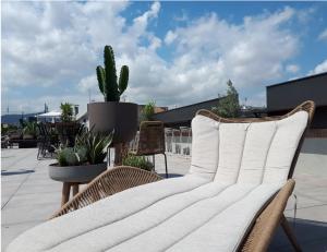 a white couch on a patio with a cactus at Silken Ramblas in Barcelona