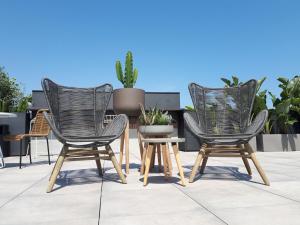 three chairs and a table on a patio at Silken Ramblas in Barcelona