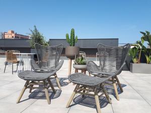 a group of chairs sitting on top of a roof at Silken Ramblas in Barcelona
