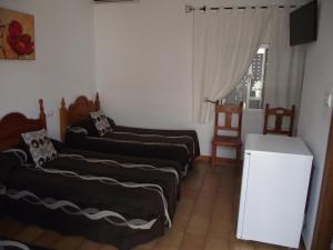 Postel nebo postele na pokoji v ubytování Hostal El Canario