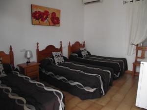 Postel nebo postele na pokoji v ubytování Hostal El Canario