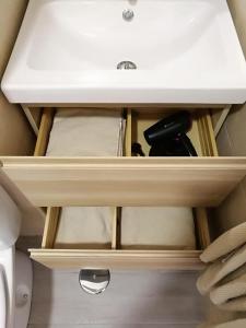 a drawer with a white sink in a bathroom at Apartamentos Playa Benitez in Ceuta