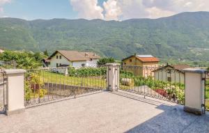an open gate to a house with mountains in the background at APPARTAMENTO Villa Isabella in Bianzone