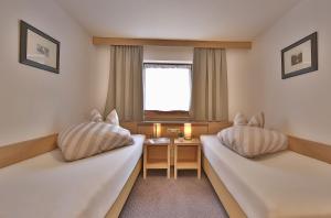 Posteľ alebo postele v izbe v ubytovaní Apartmenthaus Jörg - im Sommer INKLUSIVE Super-Sommer-Card
