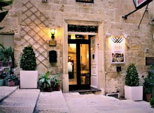 a entrance to a restaurant with a sign on the door at Casa Asti in Valletta