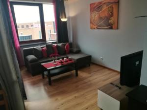 a living room with a couch and a table at Apartments 4 You in Wrocław