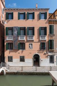 a building next to a river with a bridge at Palazzo San Lorenzo in Venice