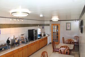 a kitchen with wooden cabinets and a table and chairs at Columbus Inn in Columbus