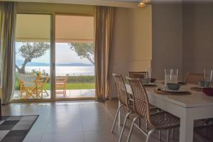 a dining room with a table and a view of the ocean at AVIA HOLIDAY HOME 2 in Avia
