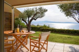 a table and chairs on a patio with a view of the water at AVIA HOLIDAY HOME 2 in Avia