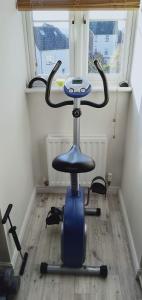 a blue office chair sitting in a room with a window at Canterbury HOMESTAY Ensuite in Canterbury