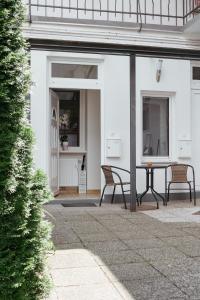 a patio with two chairs and a table at Apartments Tivoli in Ljubljana