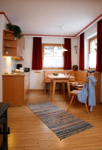 a kitchen with a table and a dining room at Alberta's Ferienhaus in Heinfels