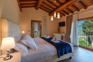 Postel nebo postele na pokoji v ubytování Borgo di Villa Cellaia Resort & SPA