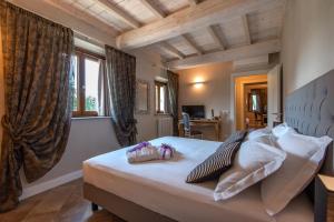 a bedroom with a bed with two bags on it at Borgo di Villa Cellaia Resort & SPA in Dicomano