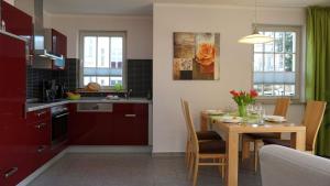 a kitchen and dining room with a table and a dining room at Villa _Duenen vis a_ vis_ _ strand in Ahlbeck