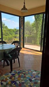 a room with a table and chairs and a large window at Casa Vacanze La Caprignola in Buccino +32 photos