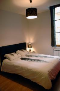a bedroom with a large white bed with pillows at Maison Renaissance Monument Historique XV ème 1497 in Villefranche-de-Rouergue