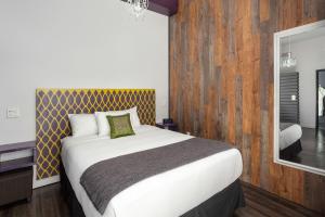 a bedroom with a bed and a dresser at Hotel Metro in London