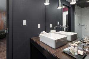a bathroom with a large white sink on a counter at Hotel Metro in London +22 photos