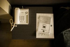 a phone and a box on a table at Hotel Nacional in La Jonquera