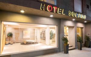 a store front of a hotel with a sign on it at Hotel Solano in Santiago del Estero