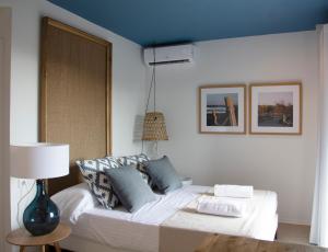 a bedroom with a bed with a blue ceiling at YOU & CO. Saler Beach Boutique in Valencia