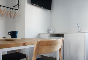 a kitchen with a wooden table and a chair at YOU & CO. Saler Beach Boutique in Valencia