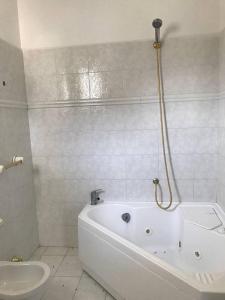 a white bathroom with a tub and a toilet at La Casa sul Fiume in Villa Santa Maria