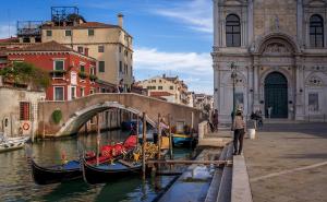 a group of gondolas in a canal next to a bridge at CANAL DREAM cosy apartment with canal view in Venice