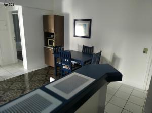 a kitchen and dining room with a table and chairs at Goldani Lexus Plaza in Florianópolis