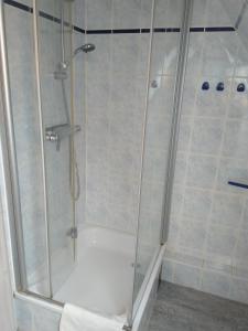 een douche met een glazen deur in de badkamer bij Ferienwohnung AMSELNEST in Kühlungsborn