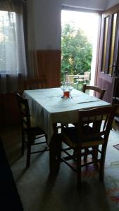 a dining room table with a white table cloth on it at Forester in Jošanička Banja