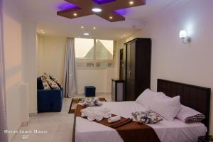 a bedroom with two beds and a ceiling at Horus Guest House Pyramids View in Cairo