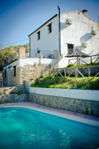 a house and a swimming pool in front of a house at La Estancia in El Bosque
